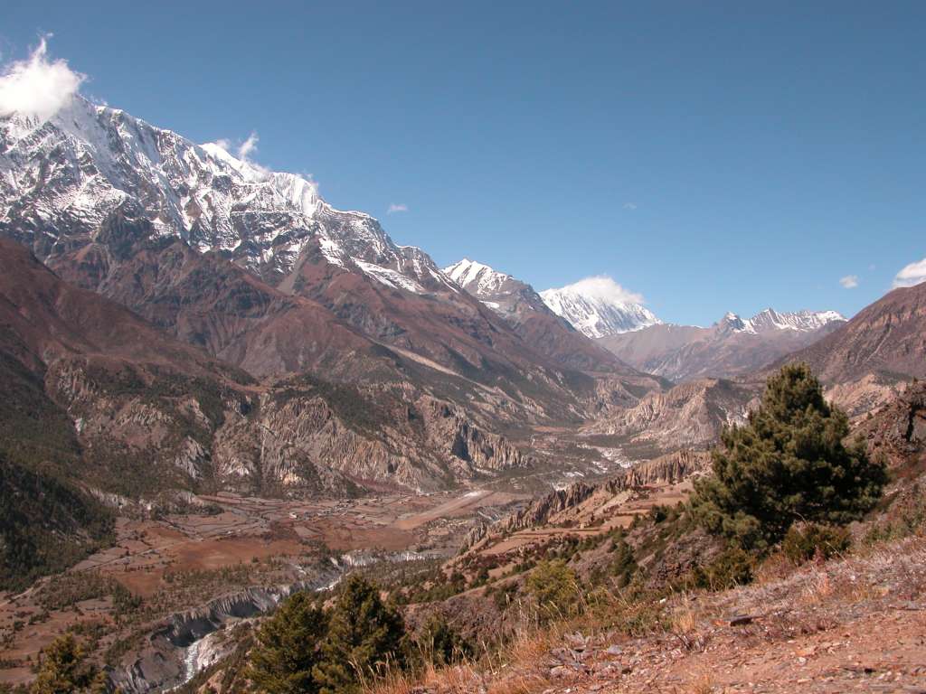 Annapurna 12 08 Looking Towards Manang From Ghyaru Looking up the valley toward Manang from Ghyaru, Annapurna III (7555m) had its head in the clouds. Just poking up behind Annapurna III was Gangapurna (7455m), and beyond Manang the Grande Barri�re was in view. The airstrip at Hongde is visible in the lower centre.